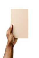 A human hand holding a blank sheet of beige paper or card isolated on a white background. ai generated photo