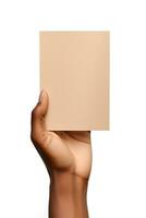 A human hand holding a blank sheet of beige paper or card isolated on a white background. ai generated photo