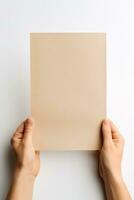 A human hand holding a blank sheet of beige paper or card isolated on a white background. ai generated photo