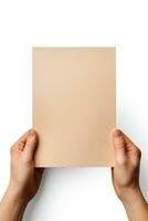 A human hand holding a blank sheet of beige paper or card isolated on a white background. ai generated photo