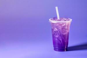 Purple drink in a plastic cup isolated on a purple background. Take away drinks concept with copy space. ai generated photo