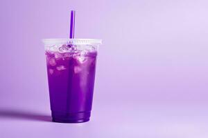 Purple drink in a plastic cup isolated on a purple background. Take away drinks concept with copy space. ai generated photo