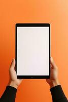 Hand holding tablet with mockup blank screen isolated on orange background. ai generated photo