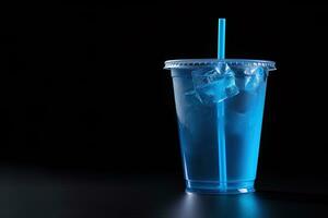 Blue drink in a plastic cup isolated on a black background. Take away drinks concept with copy space. ai generated photo