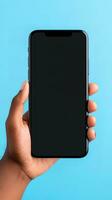 Hand holding smartphone with a black blank screen isolated on a blue background. ai generated photo