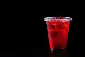 Red drink in a plastic cup isolated on a black background. Take away drinks concept with copy space. ai generated photo