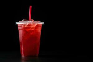 Red drink in a plastic cup isolated on a black background. Take away drinks concept with copy space. ai generated photo