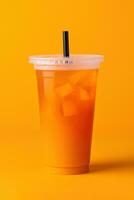 Orange color drink in a plastic cup isolated on a orange color background. Take away drinks concept. ai generated photo