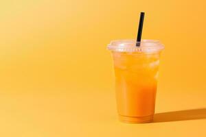 Orange color drink in a plastic cup isolated on a orange color background. Take away drinks concept with copy space. ai generated photo