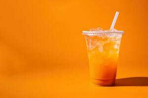 Orange color drink in a plastic cup isolated on a orange color background. Take away drinks concept with copy space. ai generated photo
