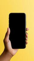 Hand holding smartphone with a black blank screen isolated on a yellow background. ai generated photo