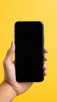 Hand holding smartphone with a black blank screen isolated on a yellow background. ai generated photo