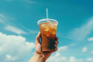 mano participación con hielo café en un el plastico taza con un azul cielo y nube antecedentes. ai generado foto