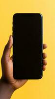 Hand holding smartphone with a black blank screen isolated on a yellow background. ai generated photo