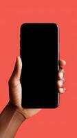 Hand holding smartphone with a black blank screen isolated on a red background. ai generated photo