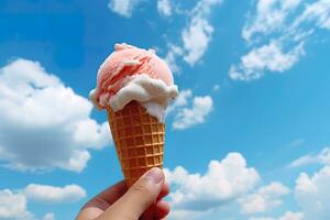 Hand holding strawberry ice cream with cone isolated on a blue sky and cloud background. ai generated photo