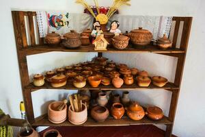 Shelves with standing on their utensils of porcelain and earthenware photo