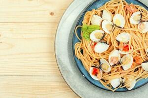 Dish of spaghetti with clams, space for text. photo