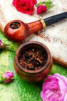 Smoking pipe and floral tobacco photo