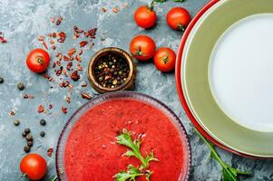 Tomato soup on stone background photo