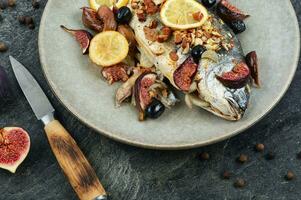 Delicious dorado fish baked with figs. photo