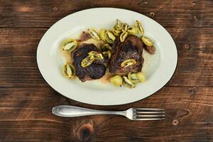 Fried ostrich steak with kiwi sauce photo