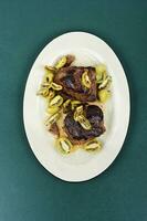 Grilled ostrich steak with kiwi berries photo