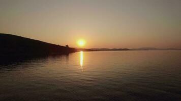 Aerial sunset scene of sea and town on shoreline, Greece video