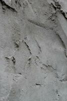 Uneven cement and sand wall texture background, grungy cement wall surface, rustic sand wall photo