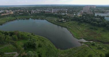 Aerial view of town with factory on the bank of water body video