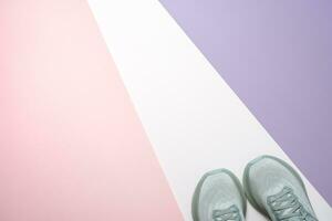 New female modern running shoe on pink purple and white photo