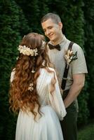 wedding walk of the bride and groom in a coniferous photo