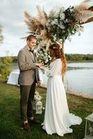 wedding ceremony of the newlyweds in a country cottage photo