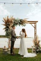 wedding ceremony of the newlyweds in a country cottage photo