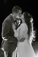 bride and groom against the backdrop of an evening wedding arch photo