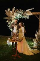 newlyweds happily cut and taste the wedding cake photo