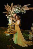 newlyweds happily cut and taste the wedding cake photo