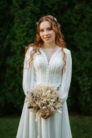 red-haired girl bride with a wedding bouquet photo