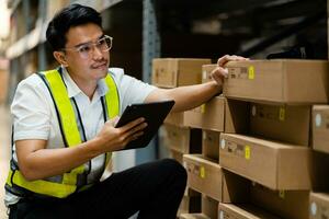 Logistics and export business concept. warehouse manager uses a tablet computer to inspect goods in a warehouse. photo