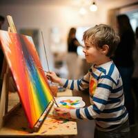 Boy painting a rainbow on a canvas photo