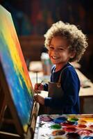 Boy painting a rainbow on a canvas photo