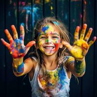 Girl with paint-splattered hands and face photo