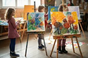 Children painting on easels in art class photo