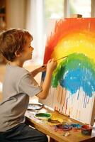 Boy painting a rainbow on a canvas photo