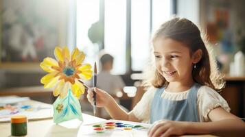 Little girl painting a flower with acrylics photo
