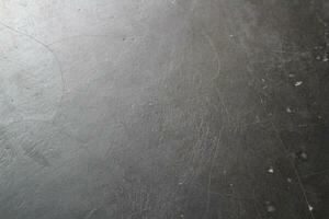 Dark cracked floor surface, shiny deep dark background, grungy floor background photo