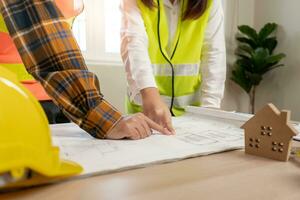 Engineers use blueprint check construction on site. Contractor and inspector inspection construction during project.civil Forman check quality assurance. Audit, inspect, quality control photo