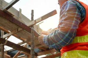 inspector or engineer is inspecting construction and quality assurance new house using a checklist. Engineers or architects or contactor work to build the house before handing it over to the homeowner photo