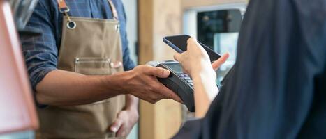 Woman use smartphone to scan QR code to pay in cafe restaurant with a digital payment without cash. Choose menu and order accumulate discount. E wallet, technology, pay online, credit card, bank app. photo