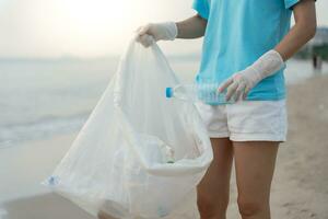 Save water. Volunteer pick up trash garbage at the beach and plastic bottles are difficult decompose prevent harm aquatic life. Earth, Environment, Greening planet, reduce global warming, Save world photo